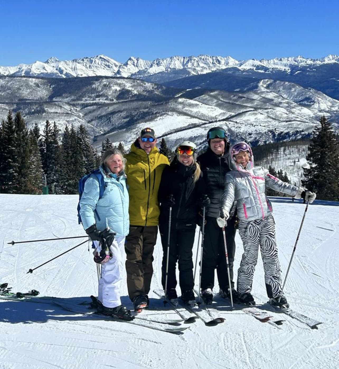 Family ski day above Vail with the Gore Range behind
