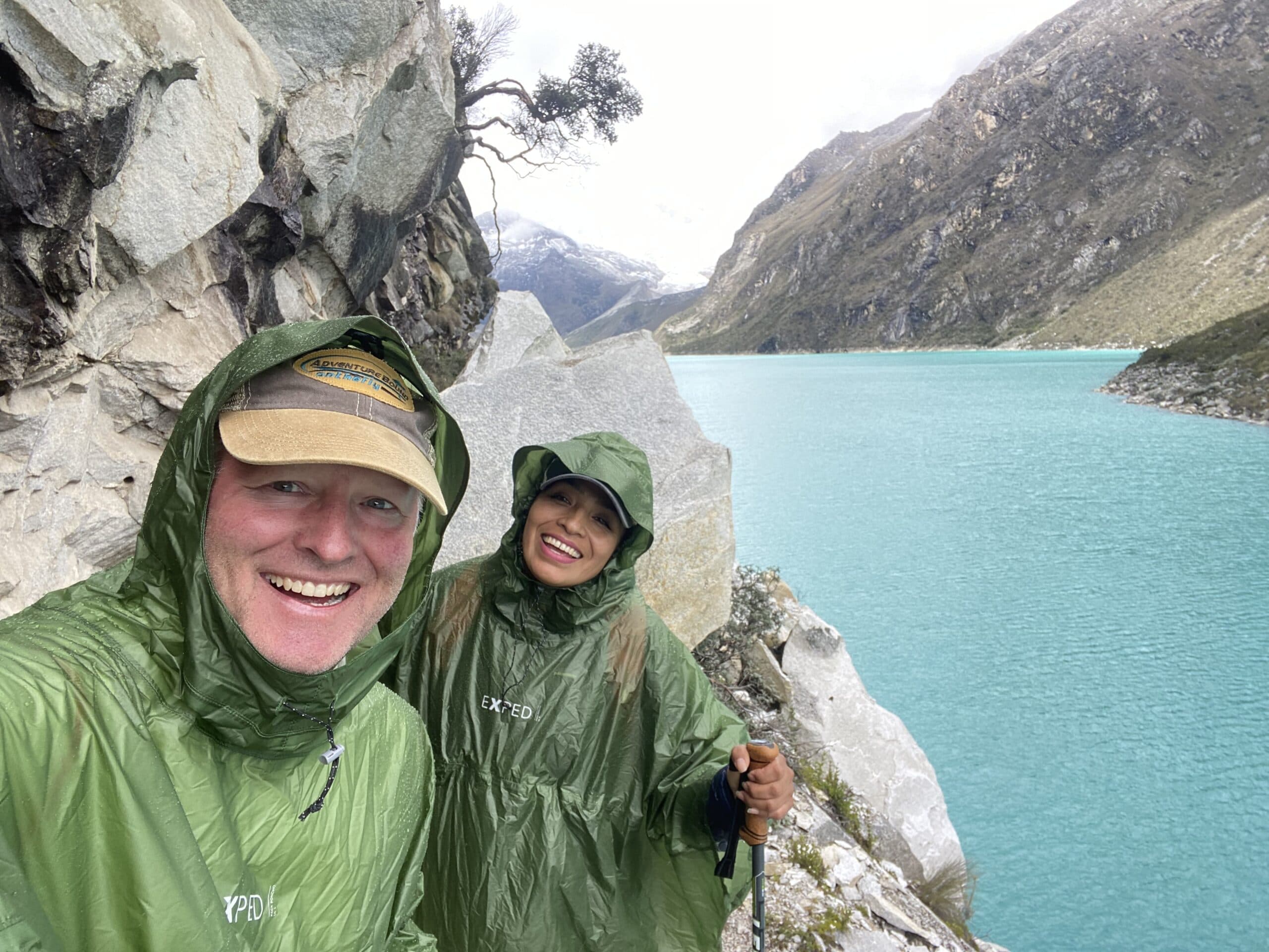 John and Gisella trekking above the turquoise water of Laguna Paron in Peru's Cordillera Blanca